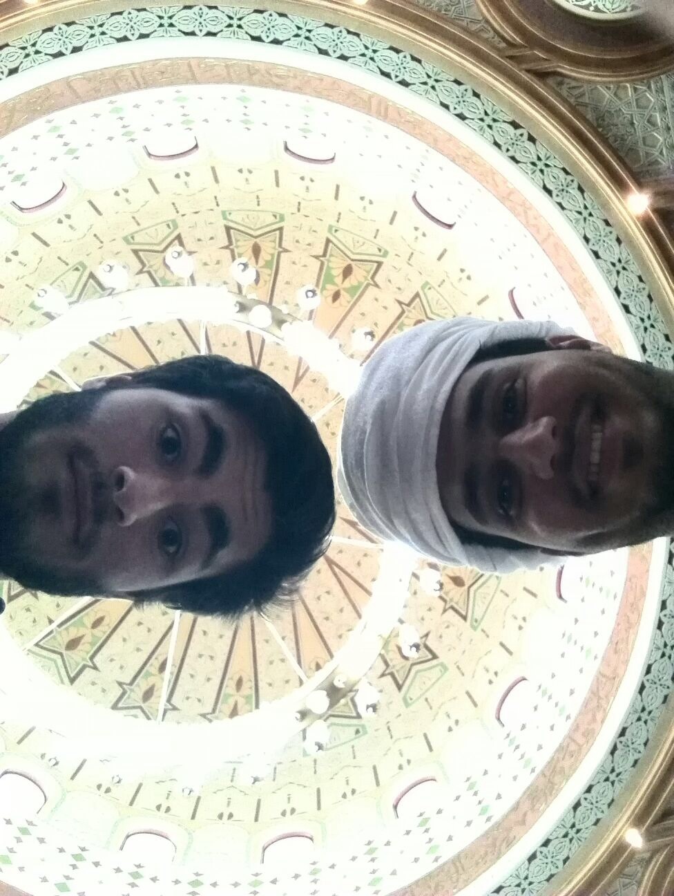 My language partner, Ahmed, and I with the ornate ceiling of a mosque above us.