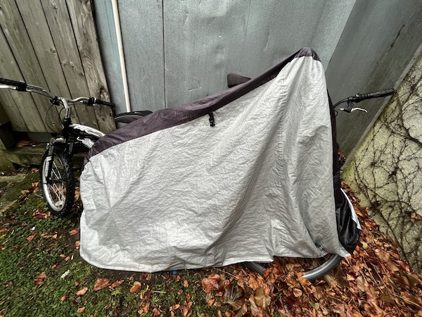 bicycle under gray plastic tarp