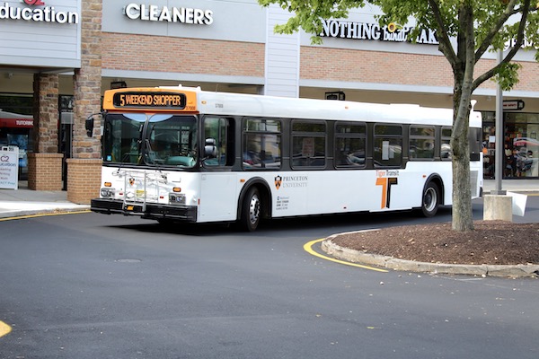 Weekend shopper bus approaching in parking lot of shopping center