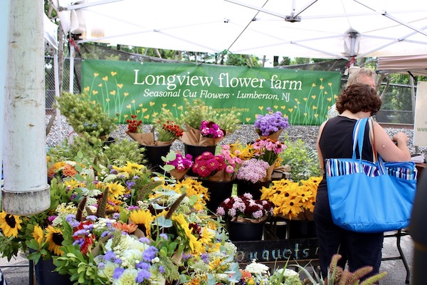 A variety of bouquets for sale under the white tent of Longview Flower Farm