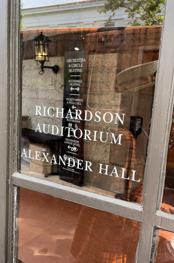White lettering on a door reads “Richardson Auditorium in Alexander Hall.”