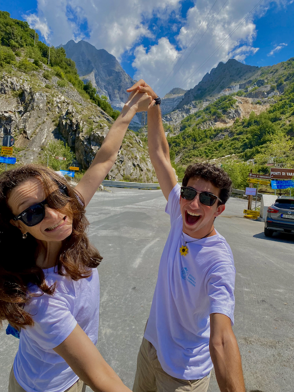 Student and professor posing in the mountains having fun