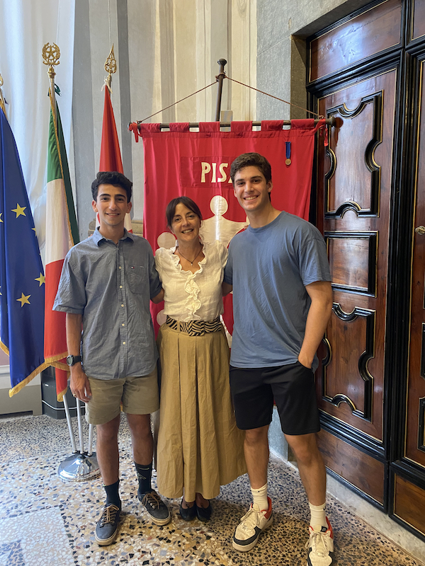 Two students posing with a woman 