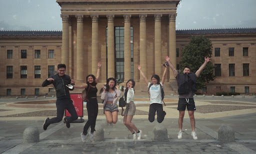 Six students jump in front of the Philadelphia Museum of Art