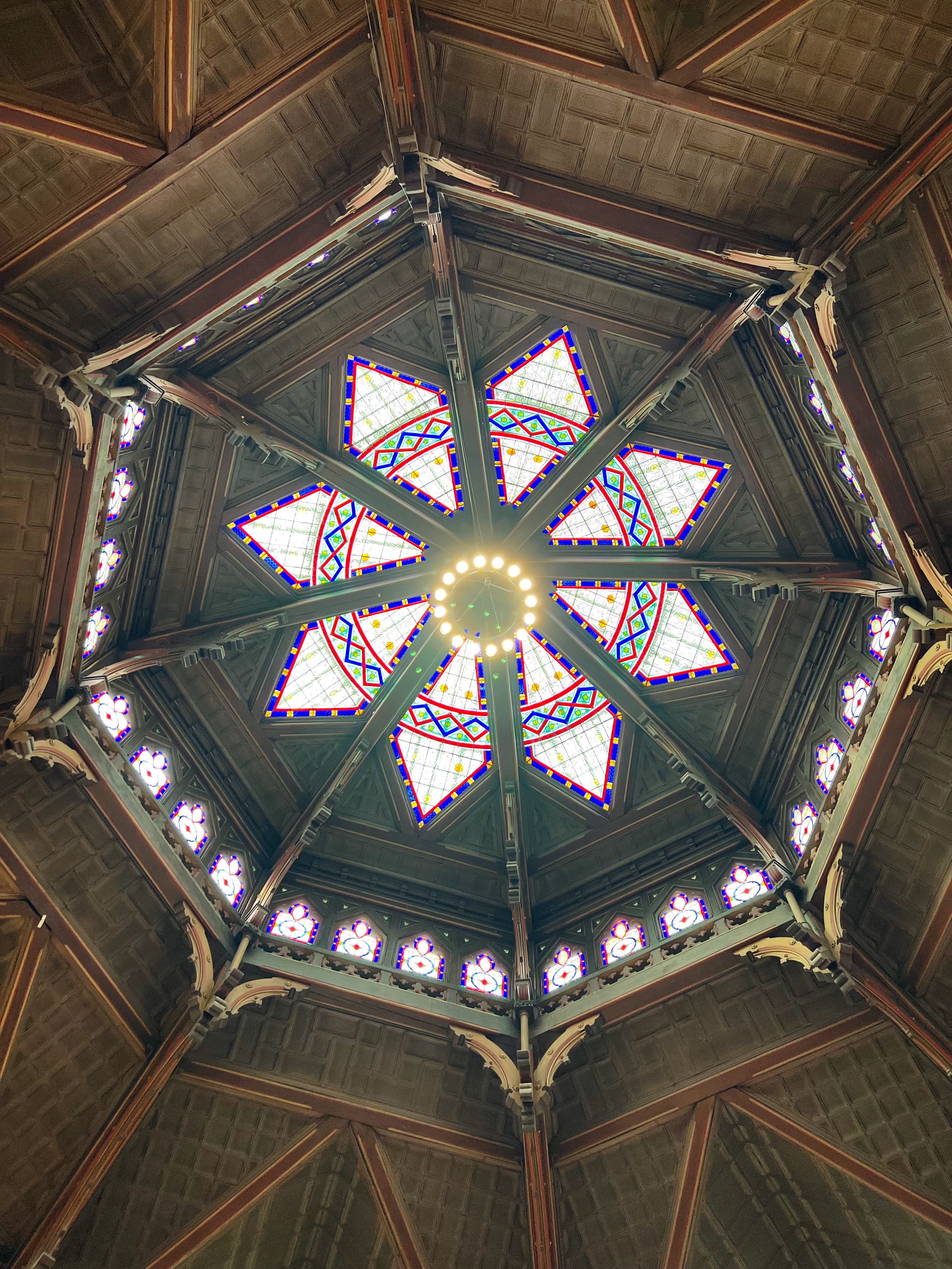 ornate ceiling of rotunda with stained glasses windows