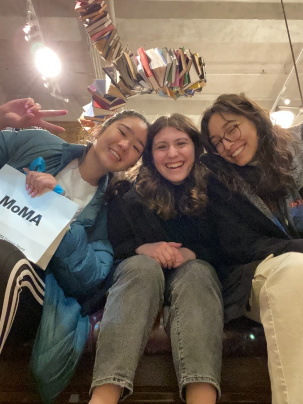 Three Princeton students smiling inside of a bookstore.