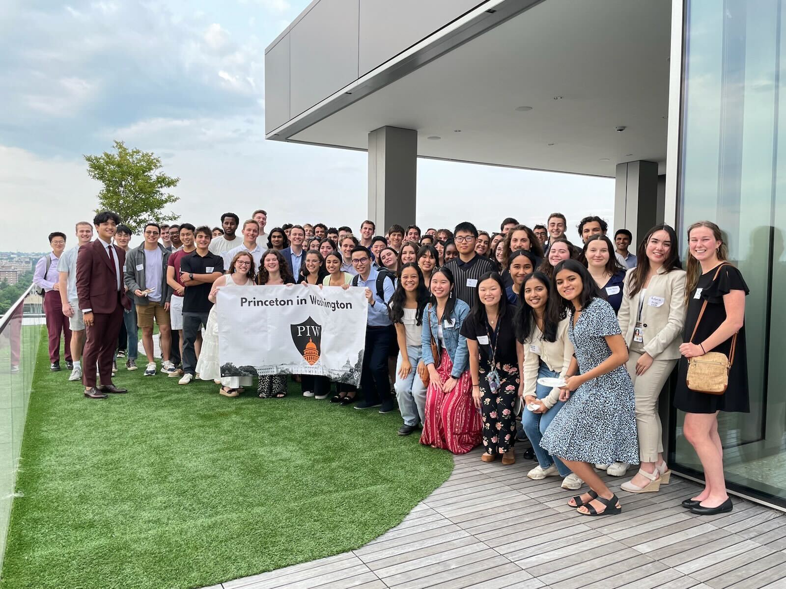 large group of students poses with 'Princeton in Washington' banner