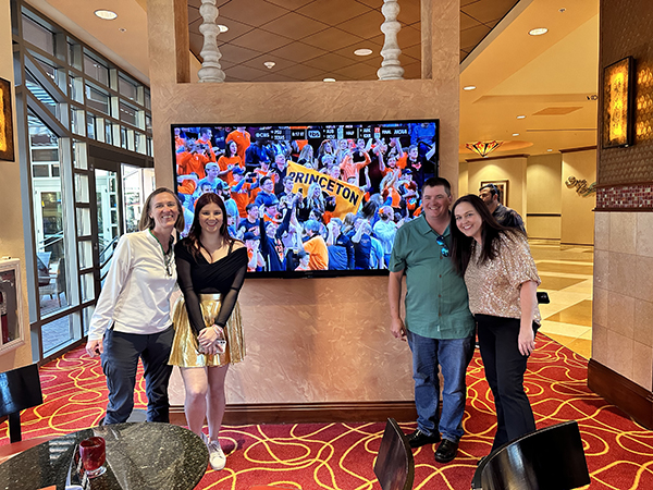 Princeton alumni gather by the tv after Princeton basketball wins