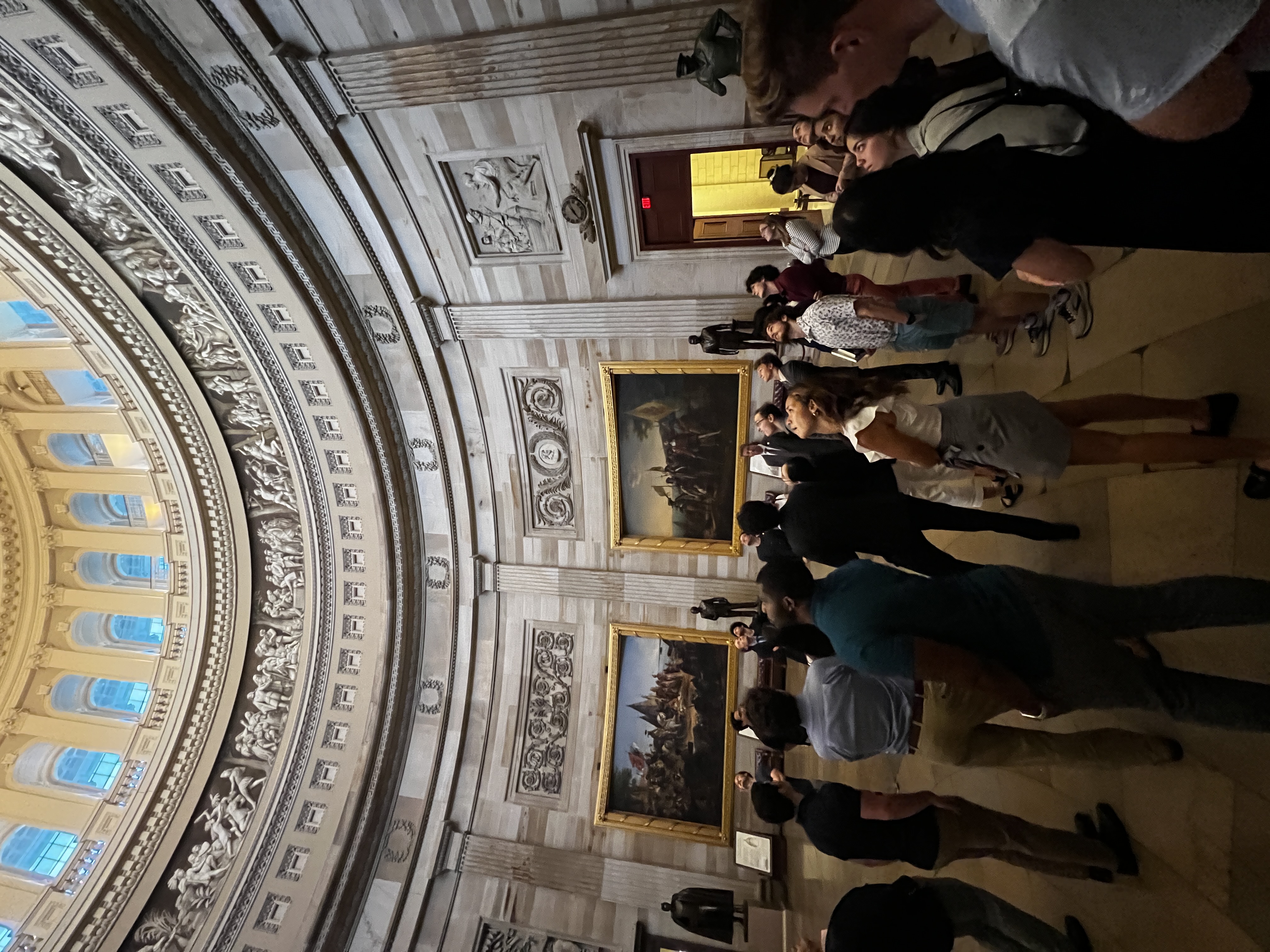 group of students look upward inside the Capital Building rotunda 