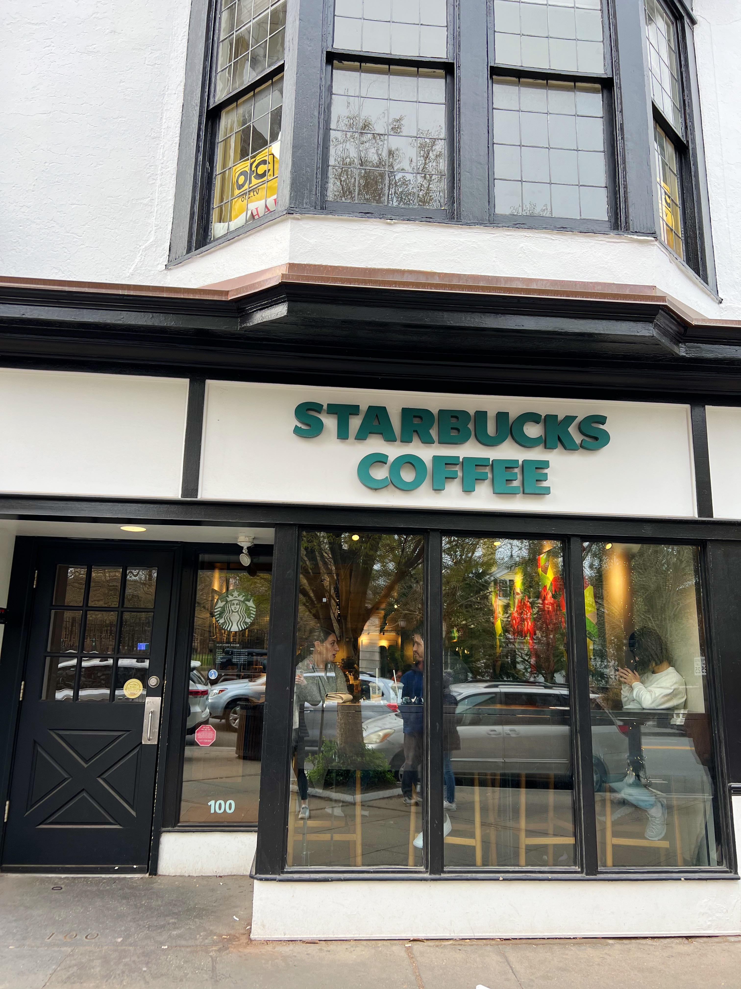 Exterior of Nassau Street Starbuck, tudor style building with green "Starbucks Coffee" lettering