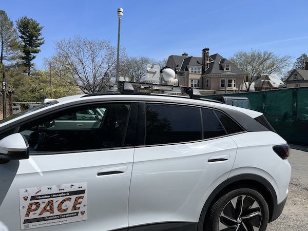 body of white car with metal measurement instruments on top