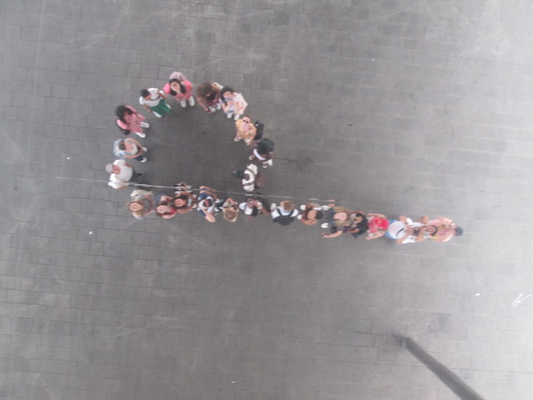 A photo of students forming the letter "P" in a mirrored ceiling.
