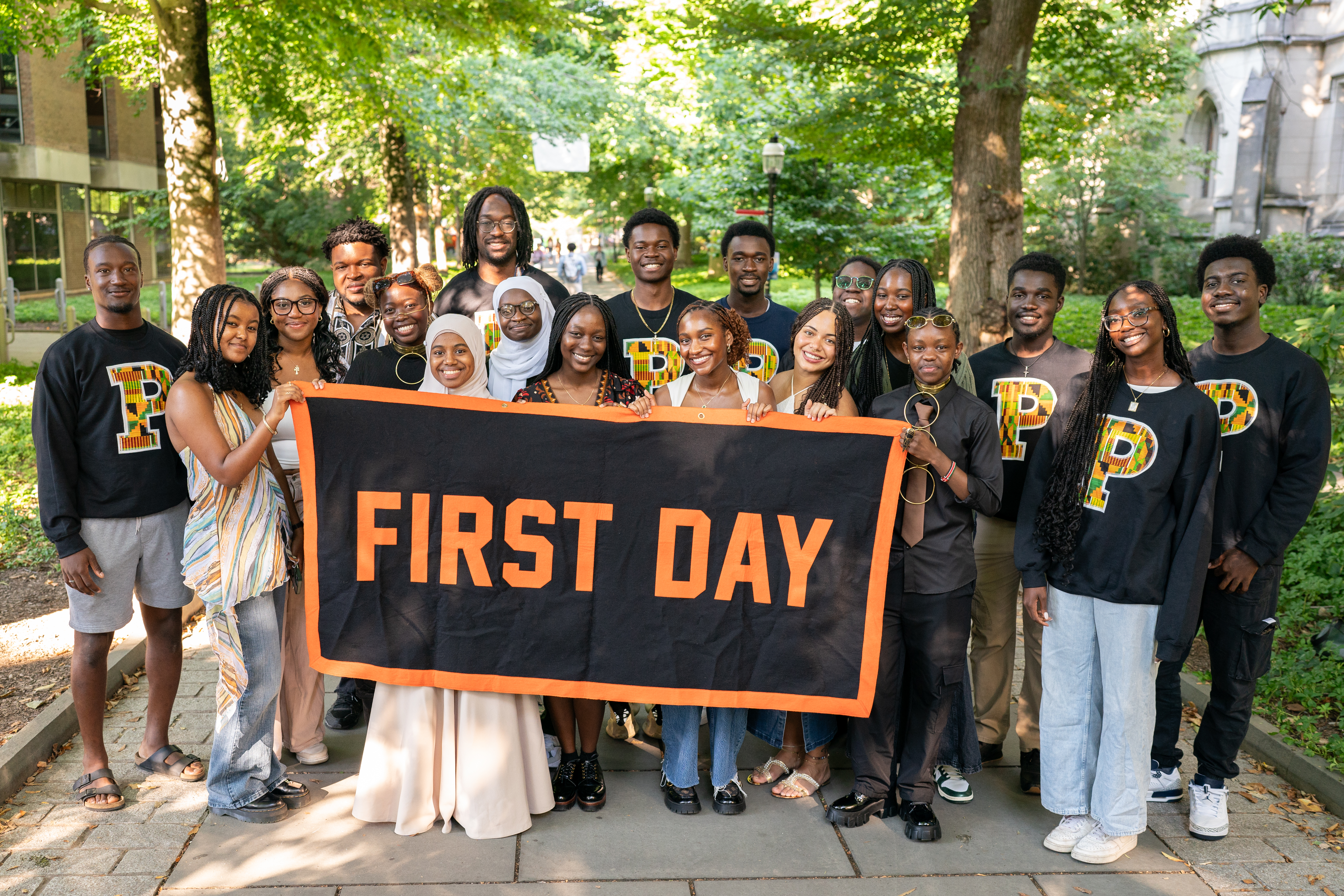 Students holding a First Day banner