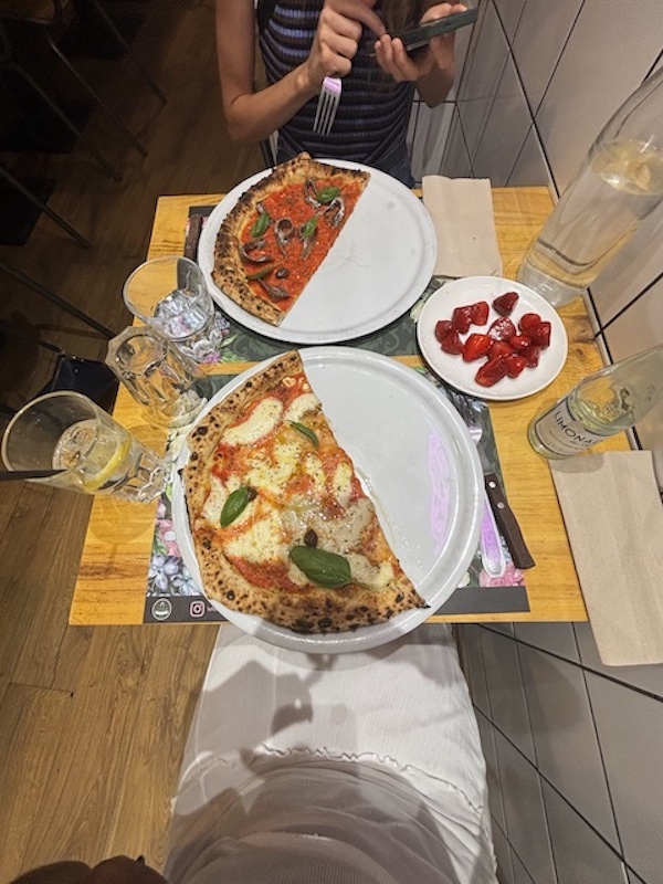 Two plates of pizza at at a wood-fire pizzeria in Aix-en-Provence.