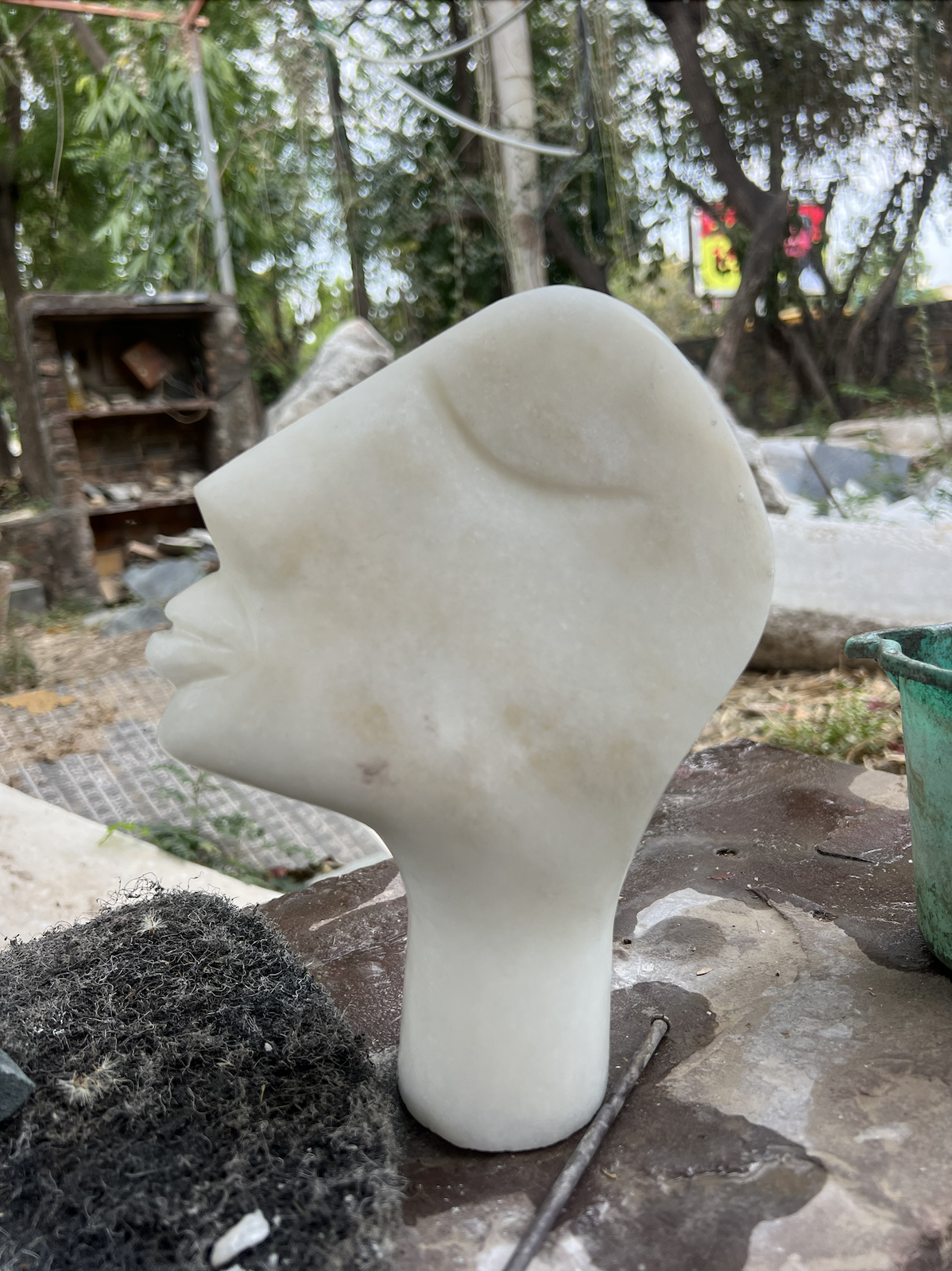 white stone carving of an abstract left facing silouette