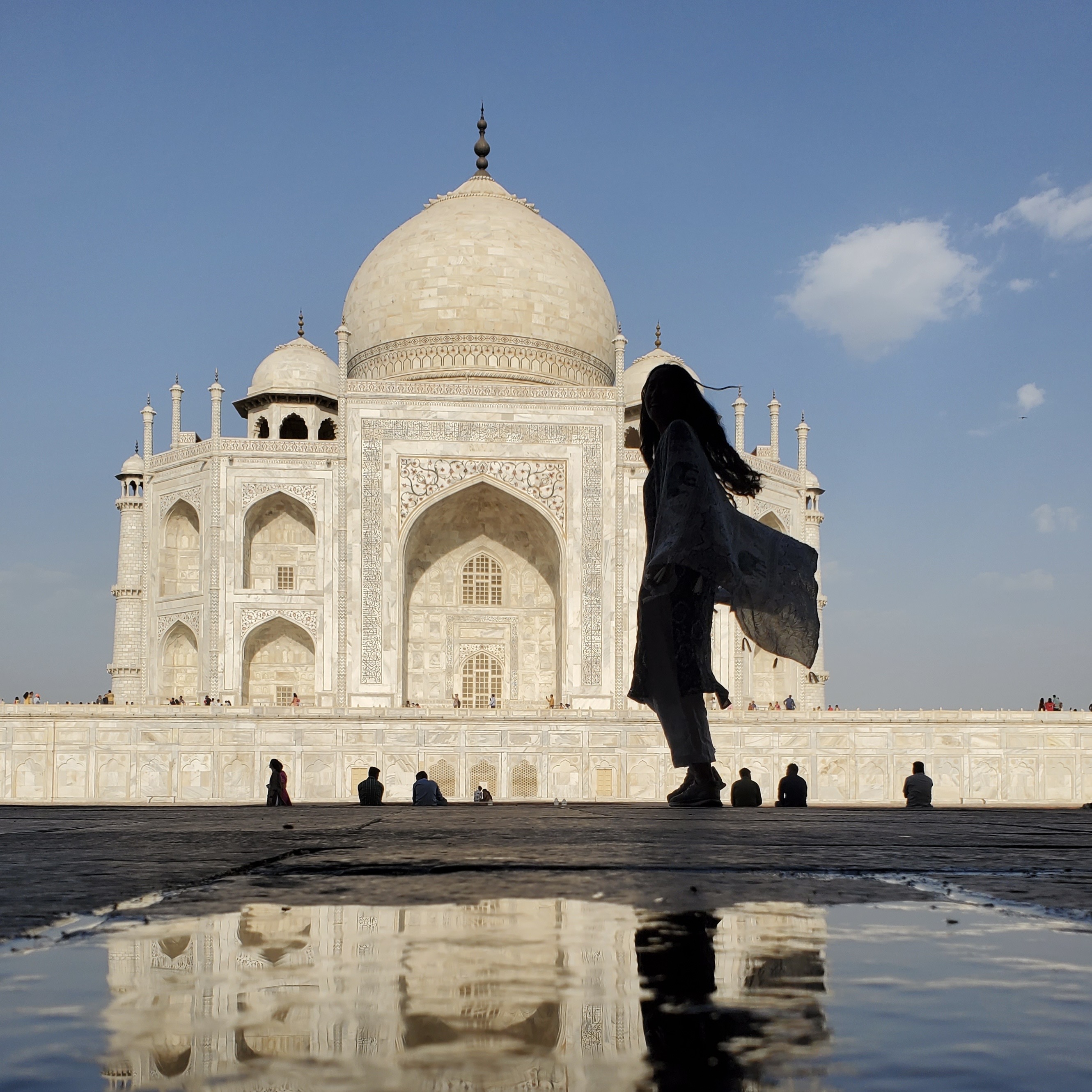 Jessica is seen mostly in shadow in front of the Taj Mahal