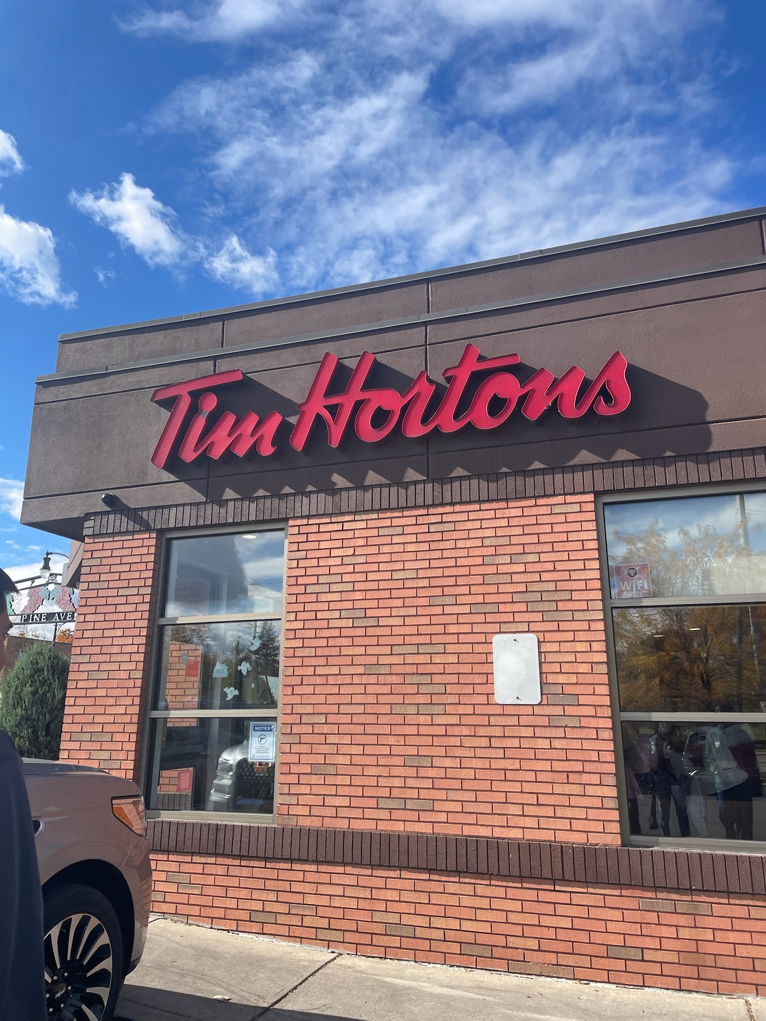 A brick building with text in red that reads "Time Hortons"