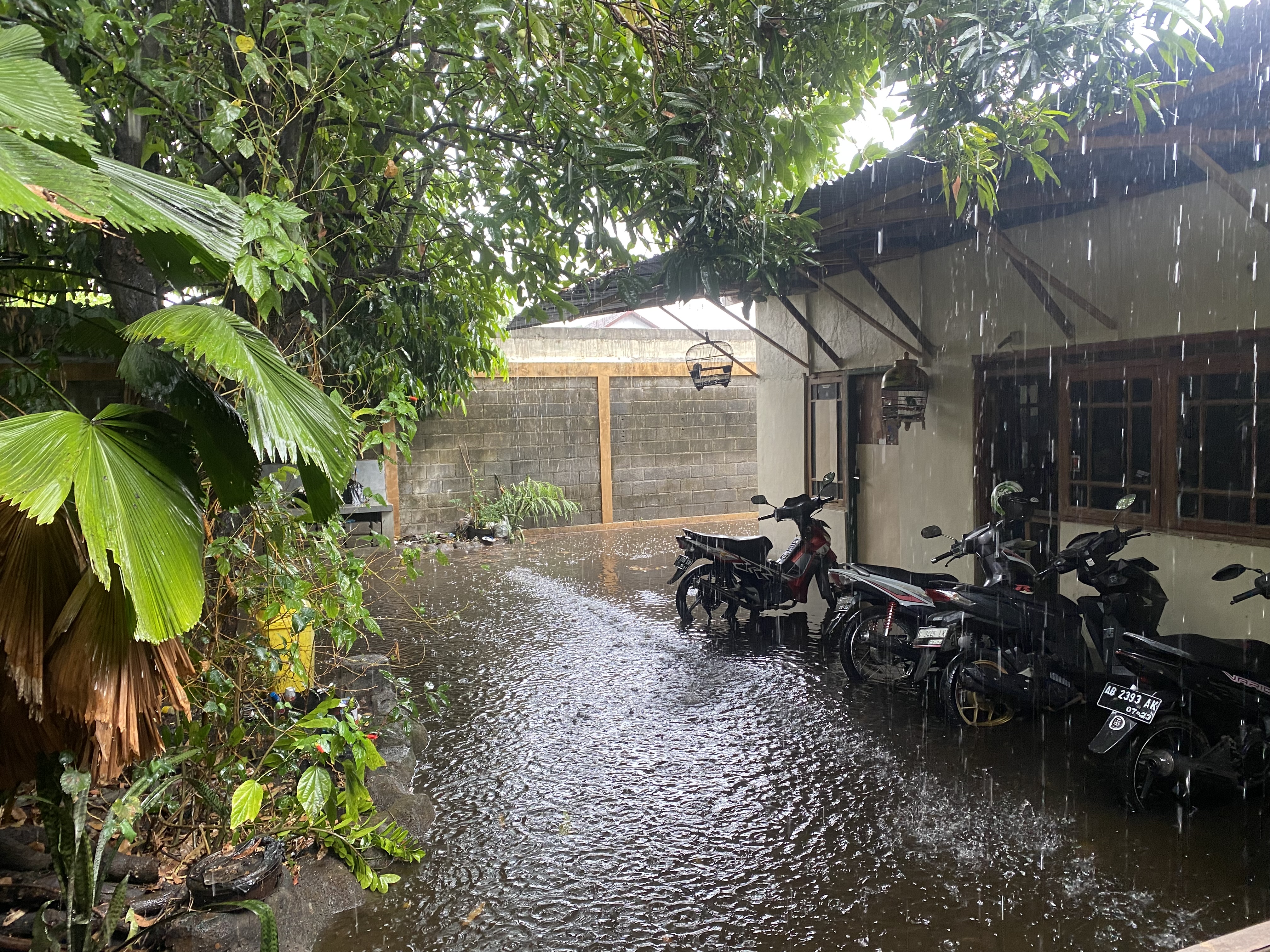 Alleyway full of motorbikes in the pouring rain