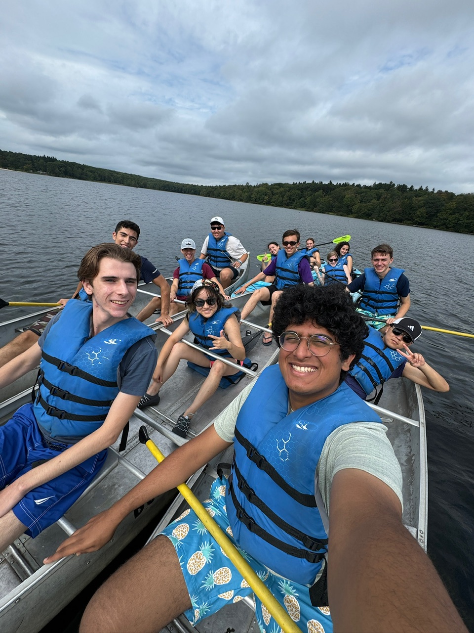 Group selfies of all the paddlers of three rafted canoes