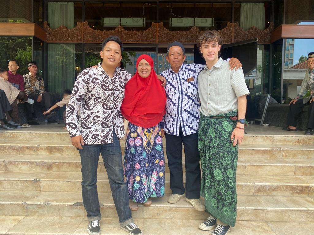 Four people stand together dressed for an Indonesian wedding