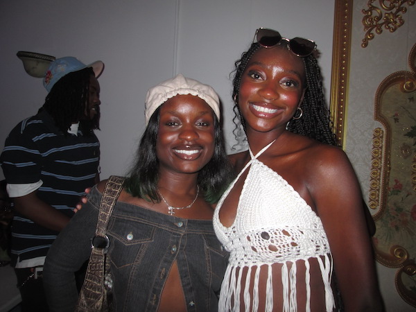 Two girls smiling for a photo against a white background