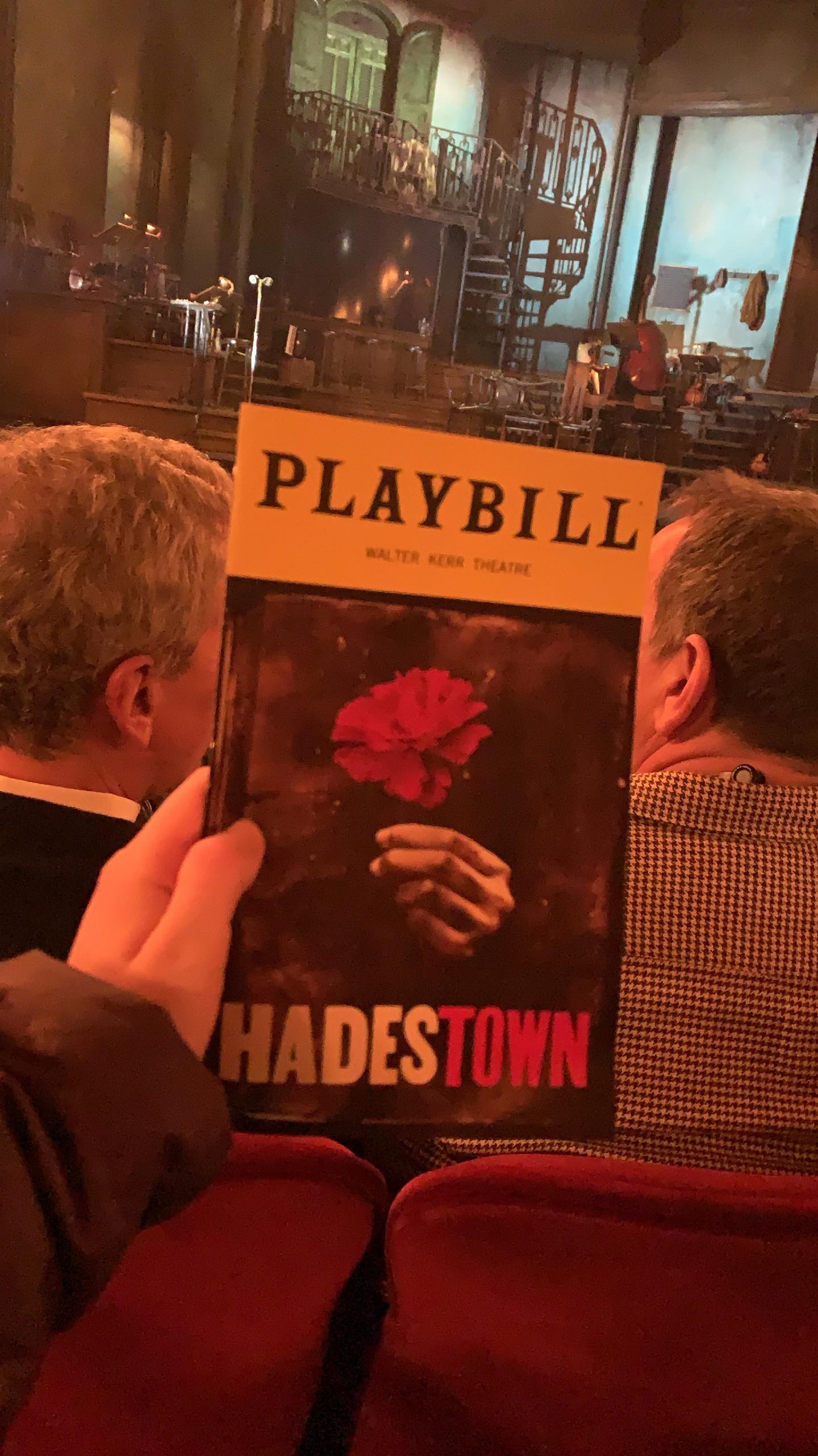 Hadestown playbill in front of stage