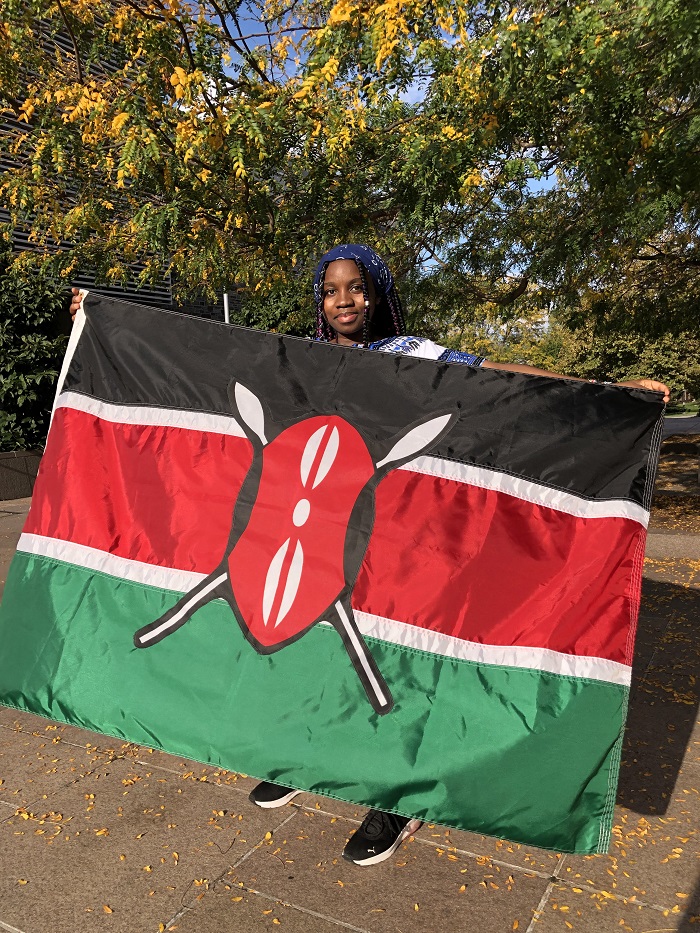 Yujin Angolio holding the national flag of Kenya