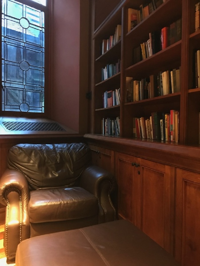 Leather chair in the corner next to a bookshelf