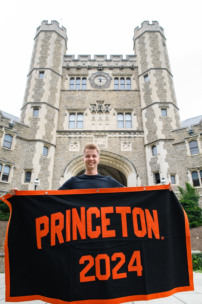 Antek standing in front of Blair Arch with his Class of 2024 banner.