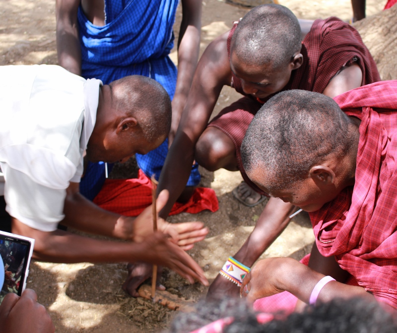 Maasai community teaching students how to start a fire