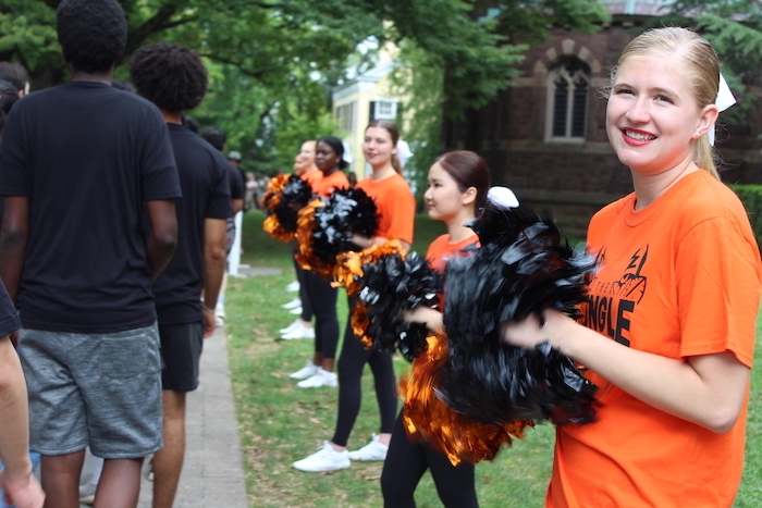 Student cheerleaders in orange and black at the Pre-rade