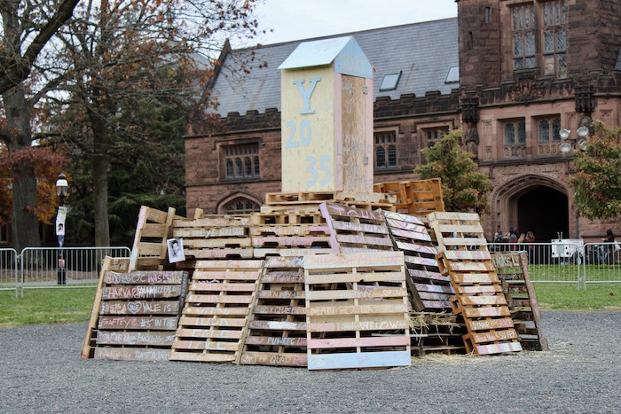 Harvard and Yale-decorated wooden crates and house on Cannon Green