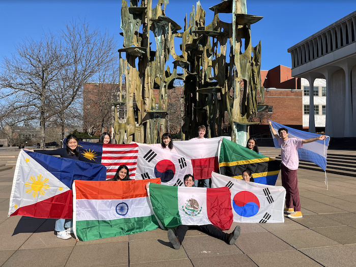 International center leaders posing in front of the SPIA fountain with flags.png
