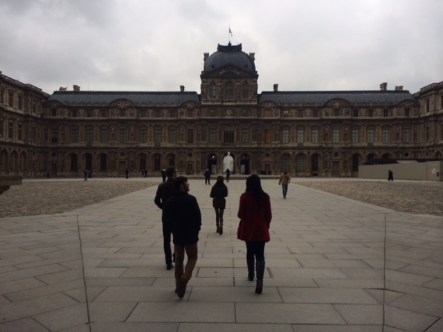 The members of l'Avant-Scène, strolling through the courtyard of the Louvre.