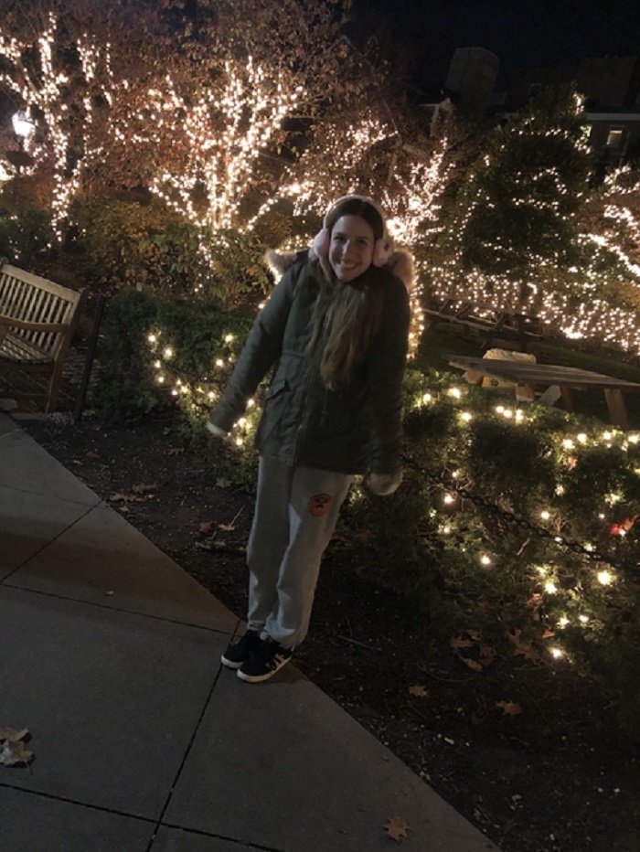 Mia in Palmer Square surrounded by holiday lights 