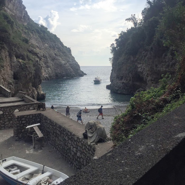 A blue ocean and sky framed by cliffs on either side