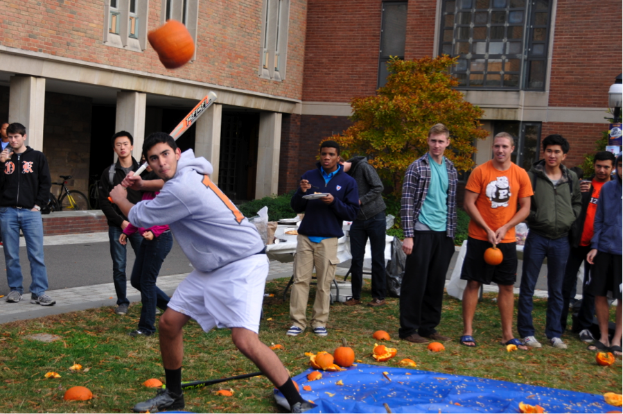 Student preparing to hit pumpkin