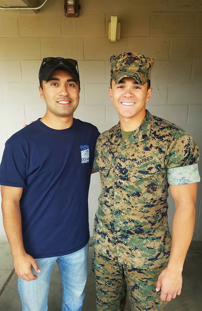 Xander dressed in a U.S. Marines uniform standing next to a friend
