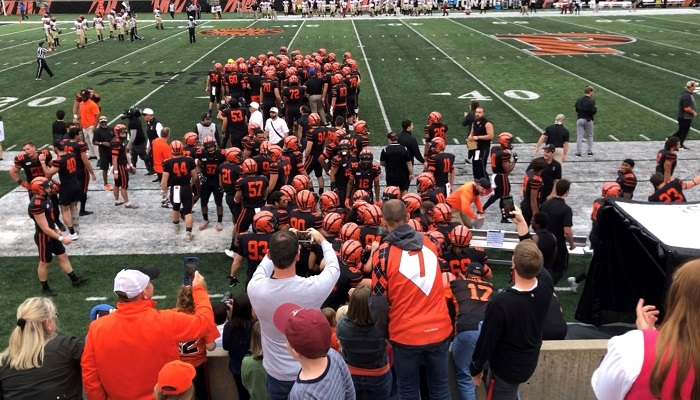 Princeton football players in a huddle on the football field during a game