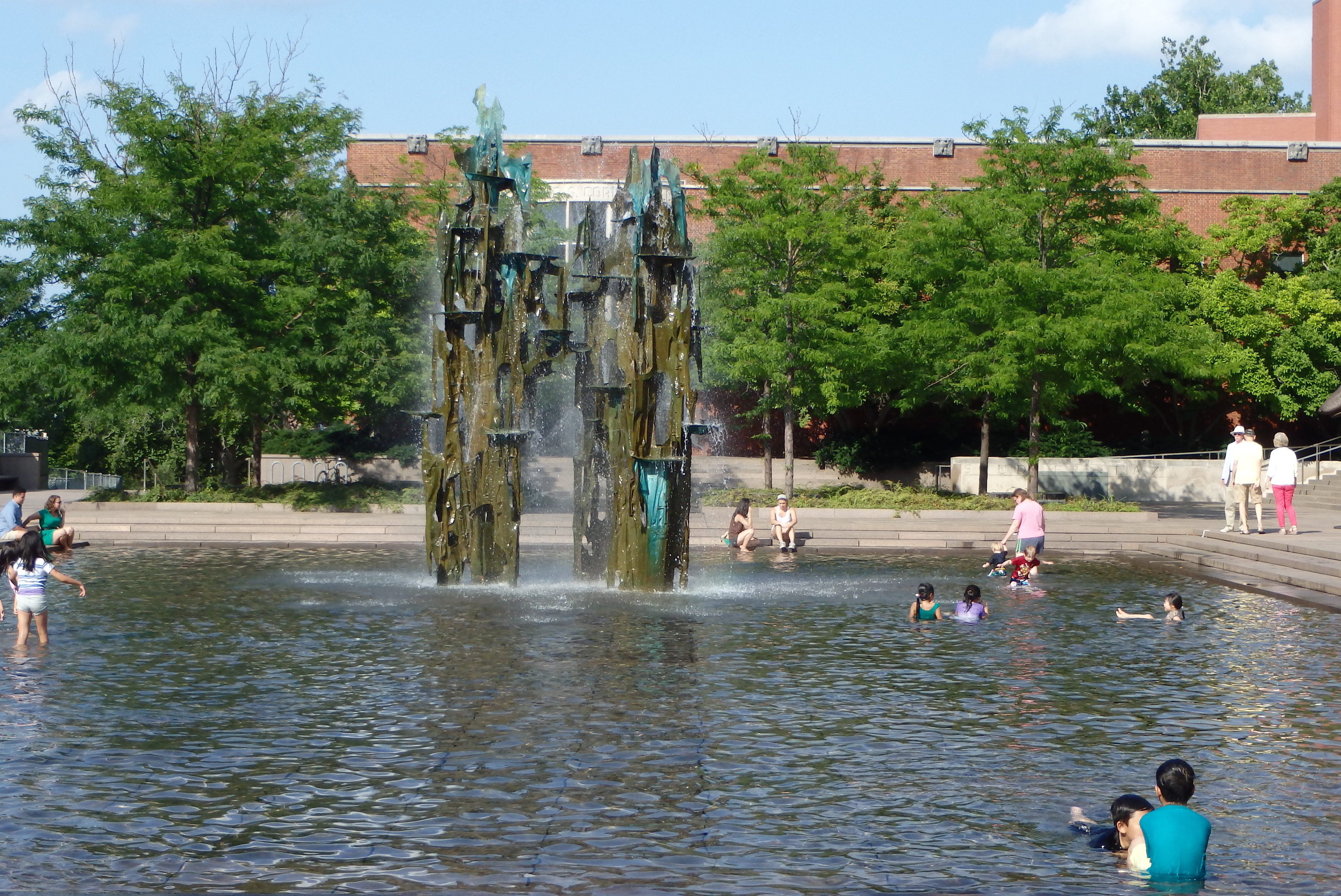 People splashing in a fountain