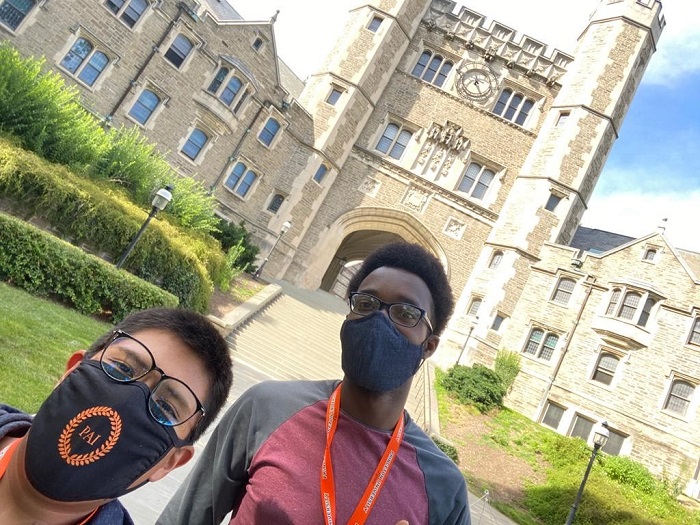 Gil and a friend in front of Blair arch on campus