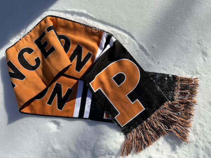 orange and black Princeton scarf laying in the snow
