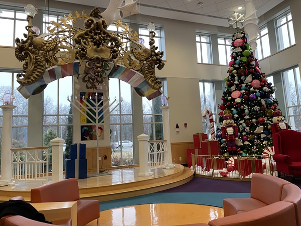 Holiday decorations and a large Christmas tree fill the hospital lobby