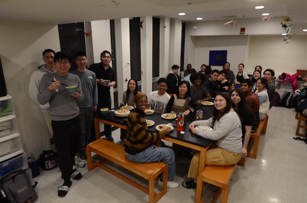 Group of people eating dinner together.