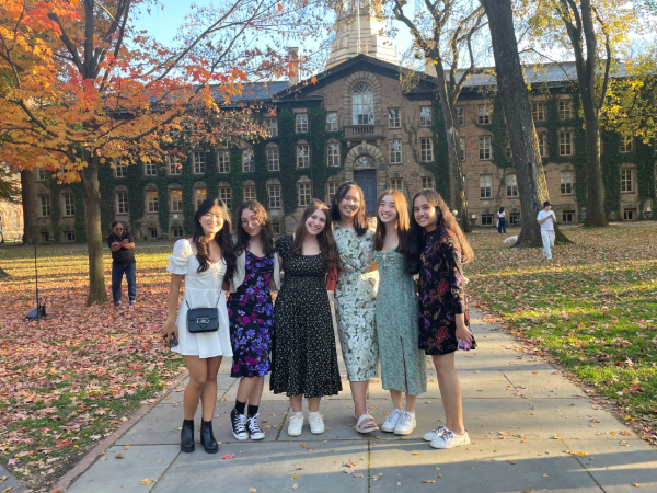 Six Princeton students stand smiling in front of Nassau Hall.