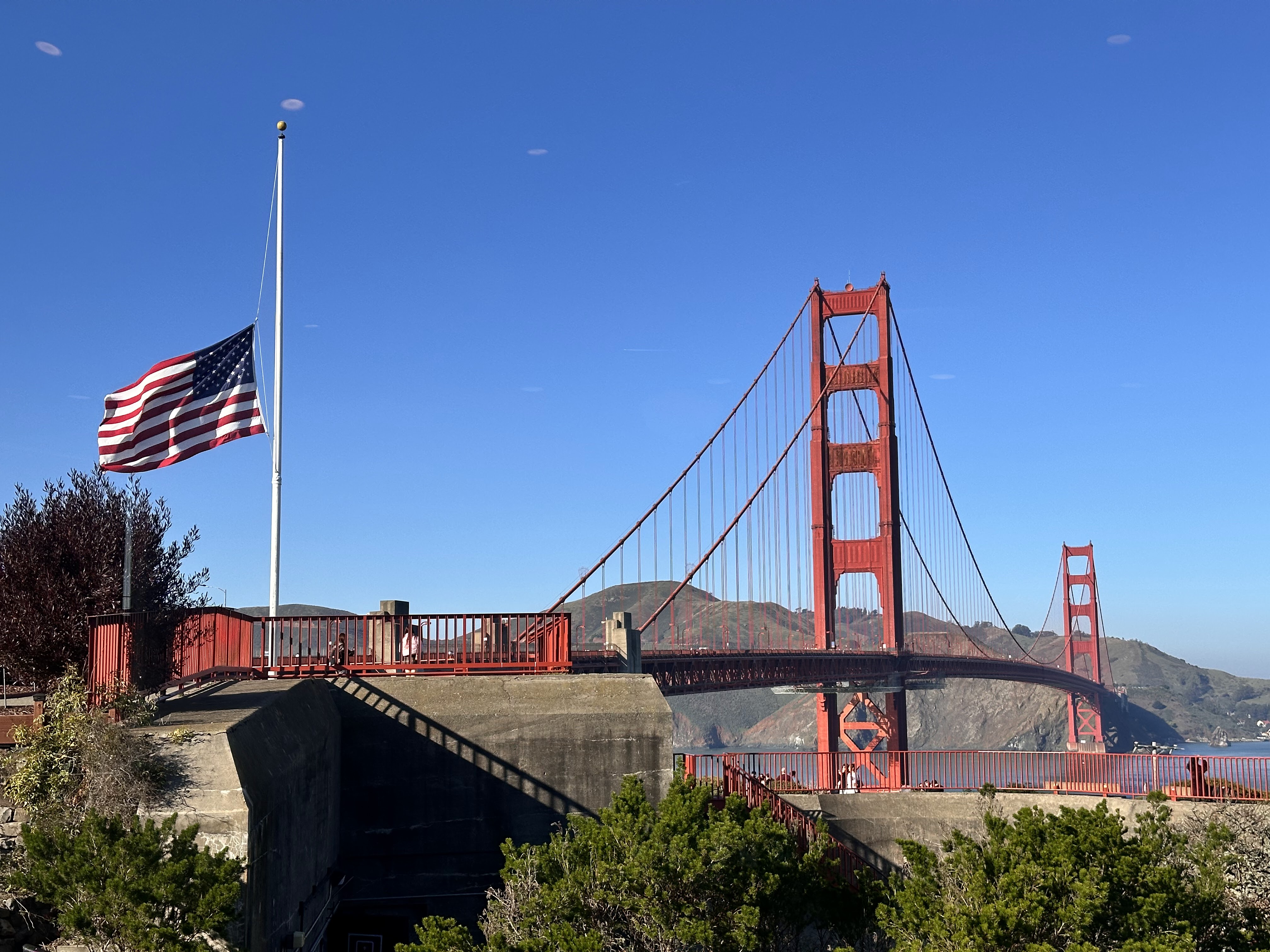 United States flag in front of the Golden Gate Bridge