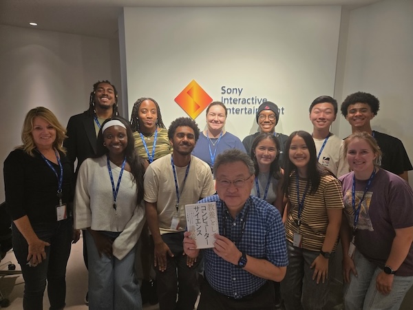 group posing in front of Sony Interactive Media sign