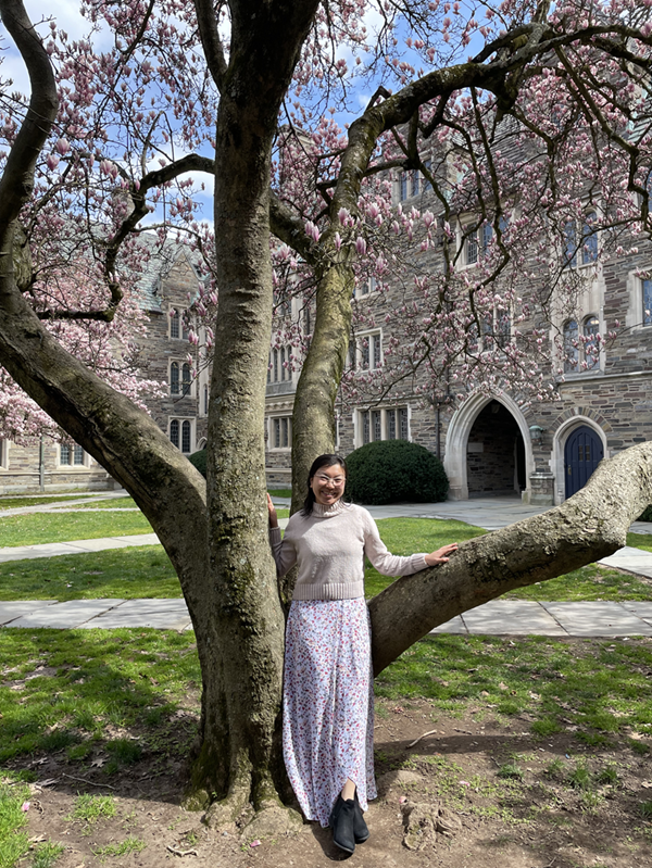 Myself leaning against a magnolia tree in front of upperclass dorms