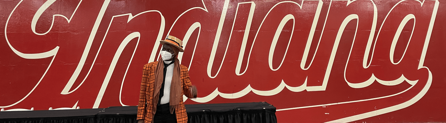 Aminah in band uniform standing in front of a painted wall that says "Indiana"
