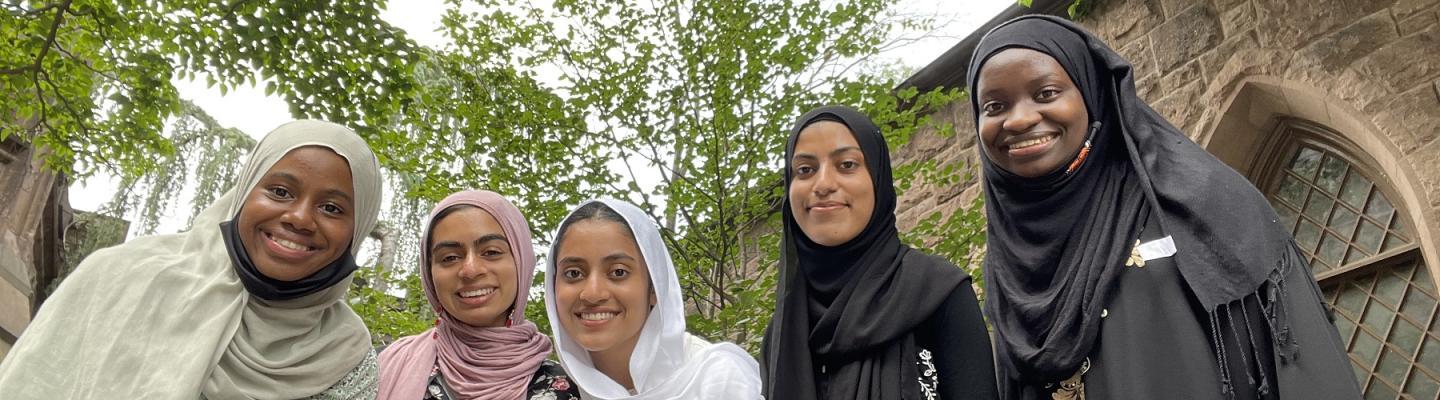 A group of four Muslimahs and I standing behind Murray-Dodge Hall